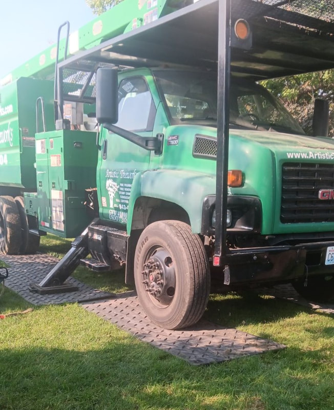 Rubber mats on grass with truck parked on mats